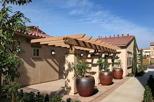 A house with a red tile roof and a wooden pergola.