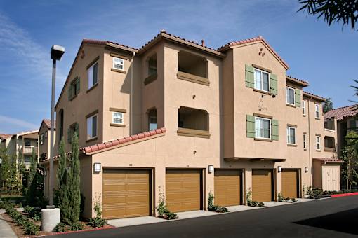 A row of houses with brown garage doors.