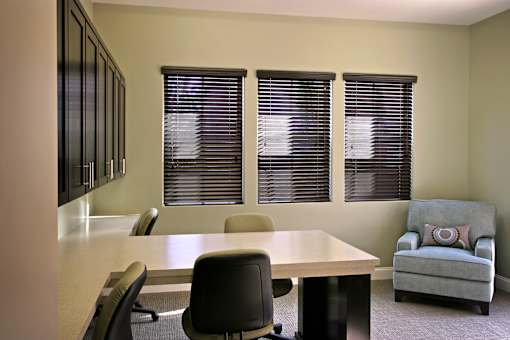 A conference room with a table, chairs, and a couch.