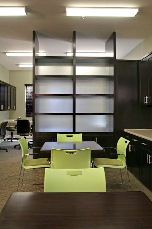 A conference room with a long table and chairs.