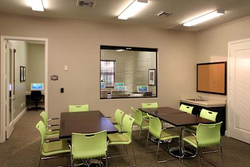 A conference room with a table and chairs.