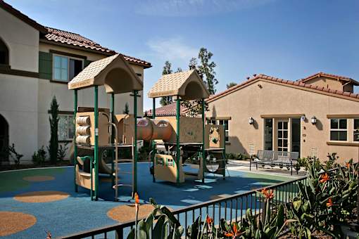 A playground with a slide, swings, and a climbing frame.