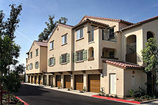A row of houses with a red tile roof.