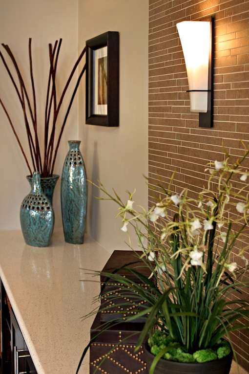 A vase with white flowers sits on a counter.