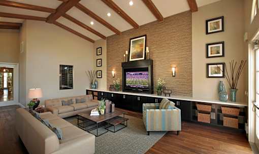 A living room with a flat screen TV and a couch.
