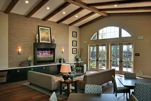 A living room with a fireplace and a painting on the wall.
