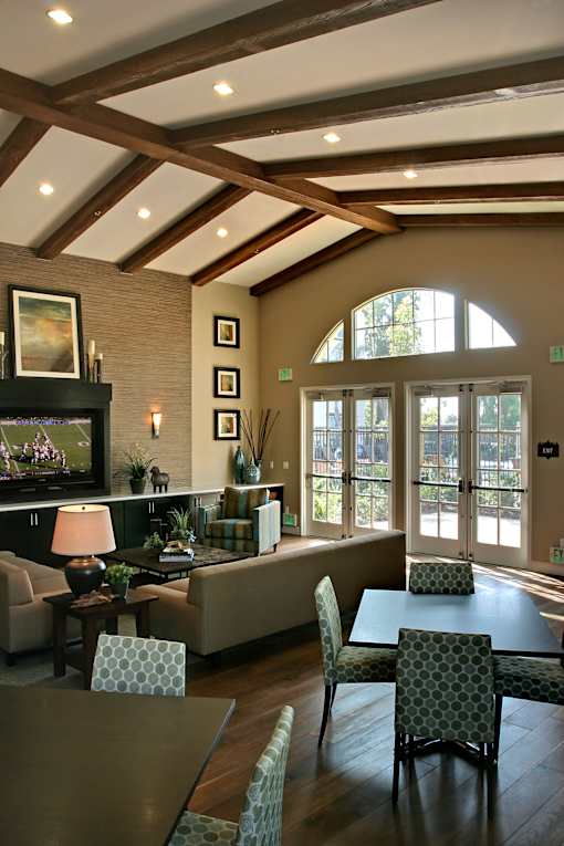 A living room with a fireplace and a painting on the wall.