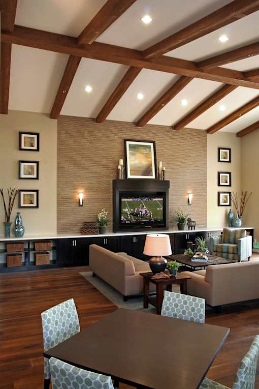 A living room with a fireplace and a television.