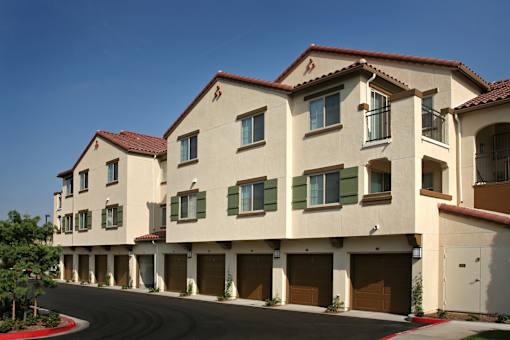 A row of houses with brown garage doors.