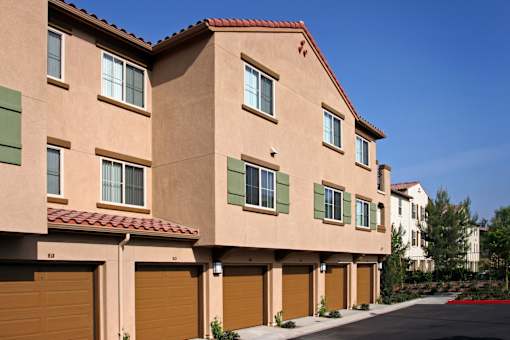 A row of houses with brown garage doors.