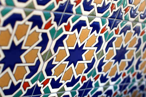 A close up of a pattern with blue and orange shapes.