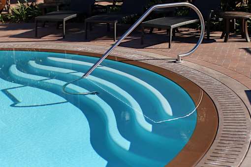 A pool with a metal ladder.
