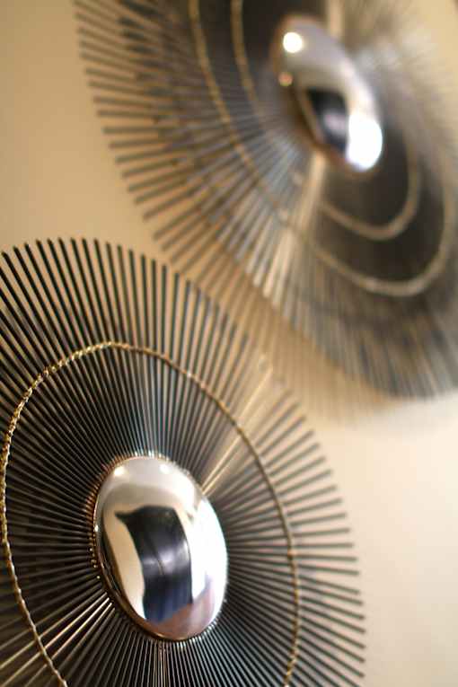 A close up of a metallic fan blade with a reflective surface.