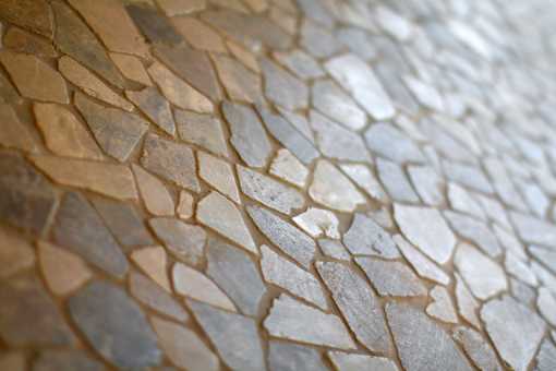 A close up of a stone wall with a variety of shapes and sizes.