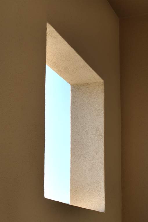 A white paper is folded in half and placed on a brown surface.
