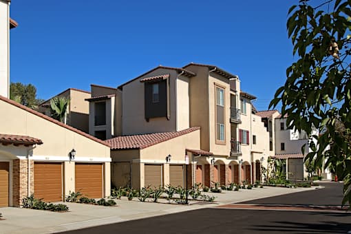 A row of houses with brown garage doors.