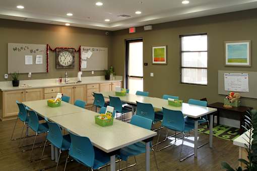 A conference room with a long table and chairs.