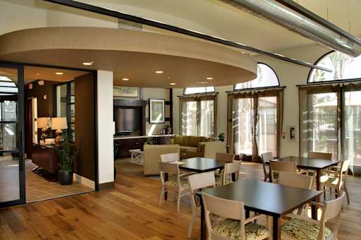 A modern dining room with a curved table and chairs.