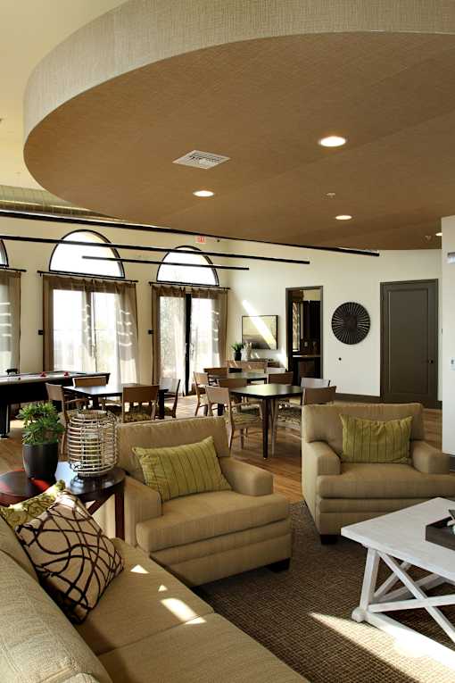 A living room with a white couch and a white coffee table.