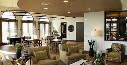 A living room with a pool table and a piano.