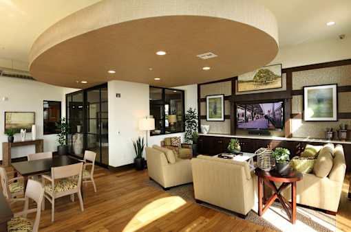 A living room with a curved ceiling and furniture.