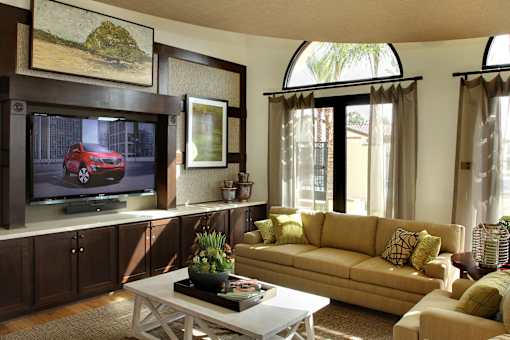 A living room with a red car on the television.