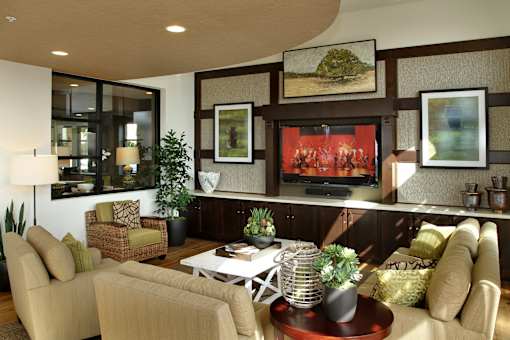 A living room with a couch, chair, and a television.