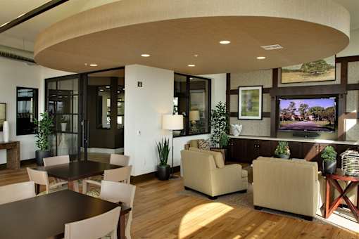 A modern living room with a curved ceiling and a flat screen TV.