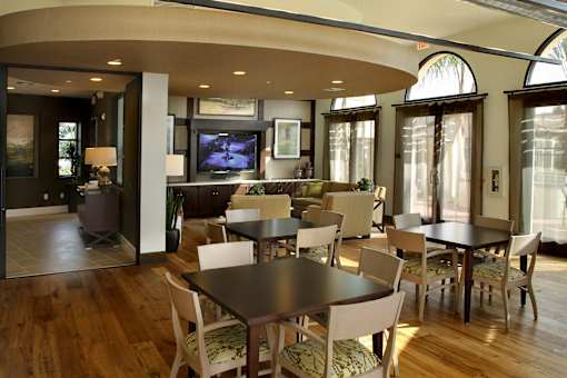 A modern dining room with a large table and chairs.