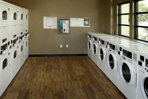 A laundromat with rows of washers and dryers.