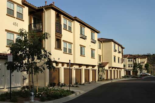 Apartment building with balconies and doors.