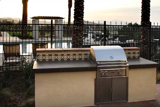 A barbecue grill is on a table outside.