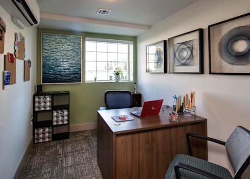 A room with a desk and a chair.