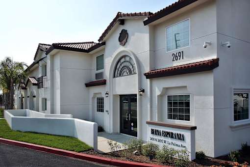 A white building with a red roof and a sign that says Real Espanola.