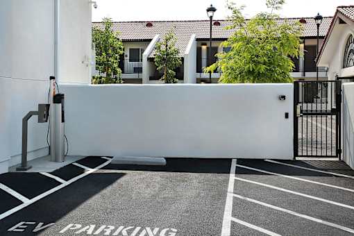 A parking lot with a sign that says "EV PARKING".
