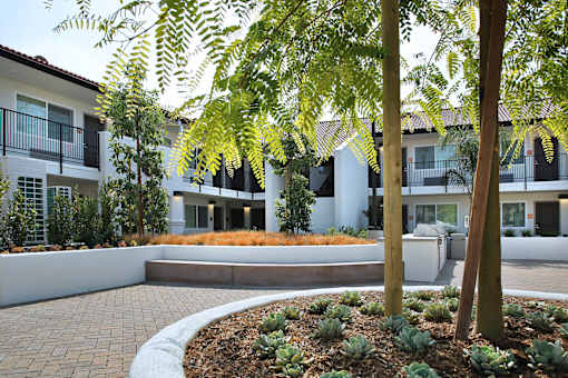 A modern building with a landscaped front yard.