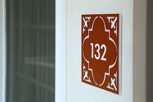A brown sign with the number 132 on it.