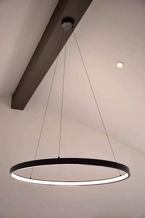 A modern circular light fixture hangs from the ceiling.
