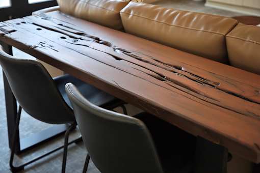 A long wooden table with chairs on either side.