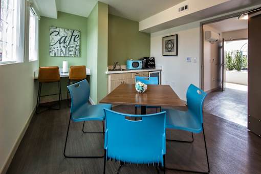 A dining room with a wooden table and blue chairs.