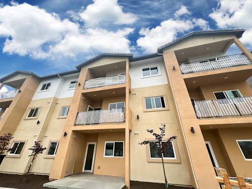 Apartment building with balconies and doors.