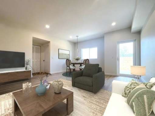 A modern living room with a wooden coffee table and a green armchair.