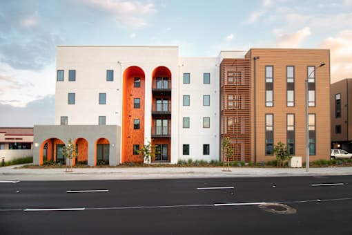 A modern building with a white facade and orange accents.