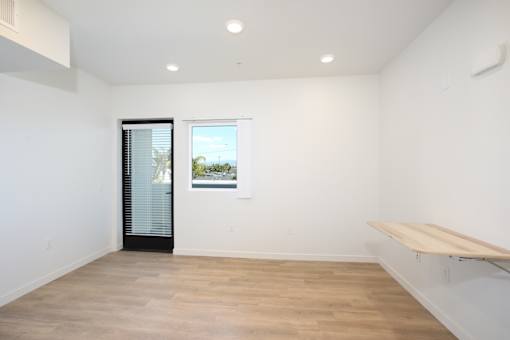 A room with a window and a bench.