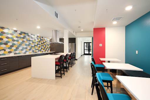 A long hallway with tables and chairs on either side.