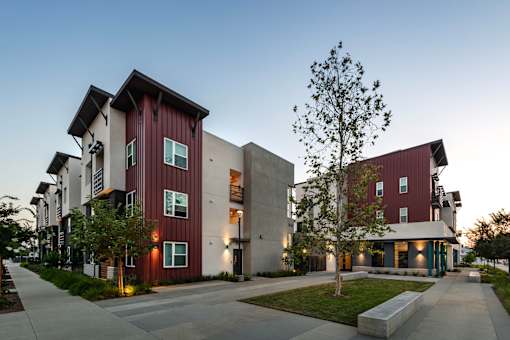 A modern building with a red and white exterior is shown.