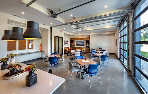 A modern dining area with tables and chairs.