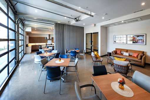 A modern dining area with a long table and chairs.