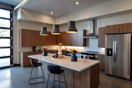 A modern kitchen with a large island and stainless steel appliances.