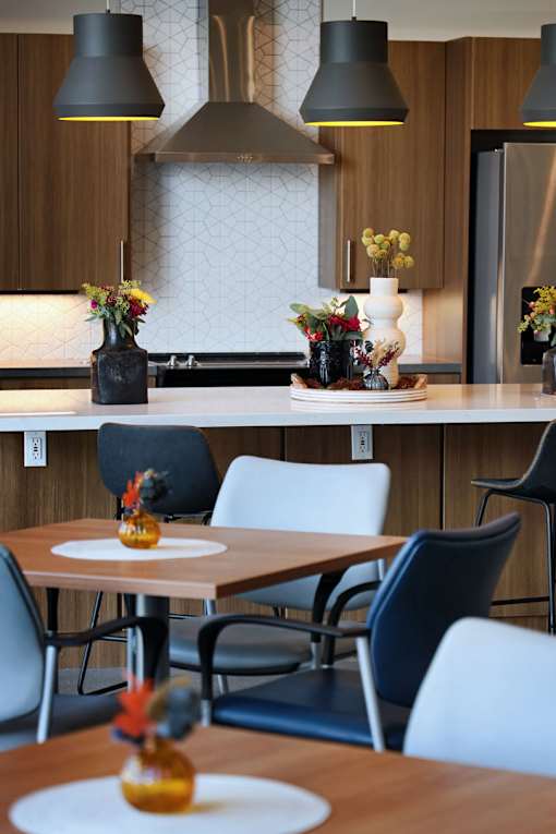 A modern kitchen with a dining table and chairs.